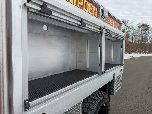 Long open side compartment running above the rear wheel area.